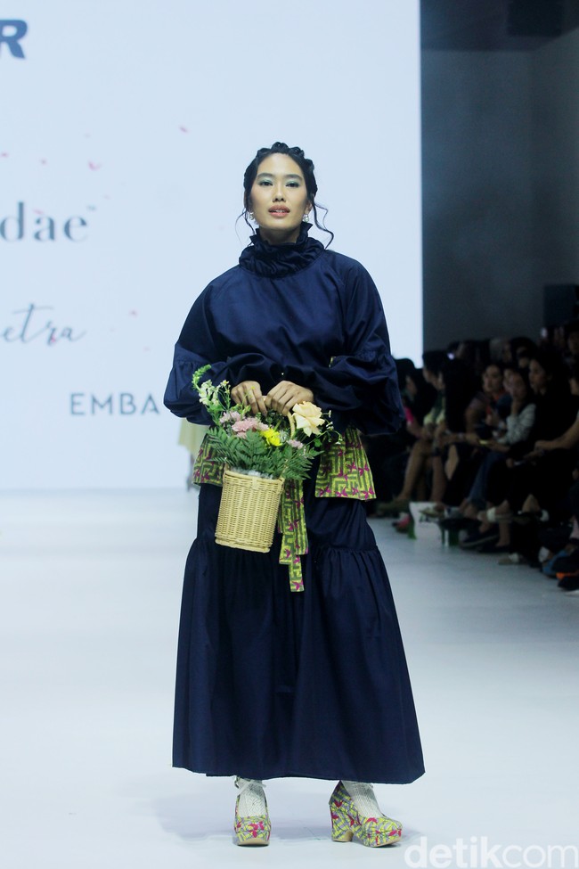 Fashion show koleksi Tities Saputra di Jakarta Fashion Week 2025, City Hall, Pondok Indah mall 3, Jakarta Selatan. Tities memamerkan rancangannya untuk lini Morphidae dan Emba Ladies. Dalam Morphidae bertema Calma, Tities menampilkan baju-baju feminin warna-warni yang bisa dipakai sehari-hari. Sedangkan untuk koleksi EMBA Ladies, Tities menampilkan revolusi denim yang lebih chic. Foto: Mohammad Abduh/detikcom.