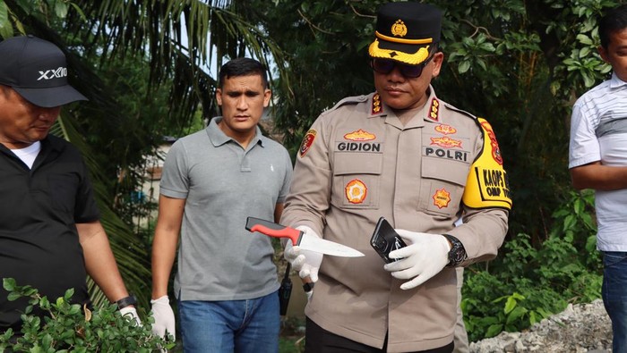 Kombes Gidion saat memegang pisau yang digunakan pelaku melukai korban. Foto: Dok. Polrestabes Medan