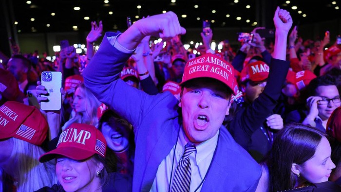 Supporters of Republican presidential nominee and former U.S. President Donald Trump celebrate after the Fox Network called the election in his favor at the site of his rally, at the Palm Beach County Convention Center in West Palm Beach, Florida, U.S., November 6, 2024. REUTERS/Brian Snyder