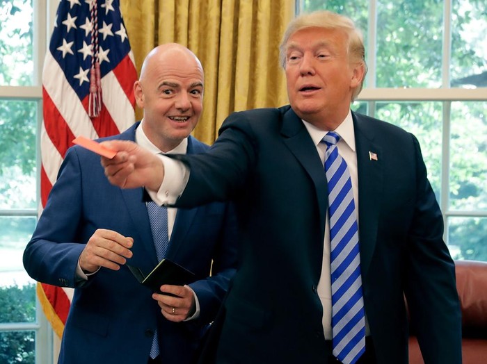 WASHINGTON, DC - AUGUST 28:  U.S. President Donald Trump pretends to give a red card to members of the news media with FIFA President Gianni Infantino in the Oval Office at the White House August 28, 2018 in Washington, DC. The 2026 FIFA World Cup will be jointly hosted by the United States, Canada and Mexico and will be the first World Cup in history to be held in three countries at the same time.  (Photo by Chip Somodevilla/Getty Images)