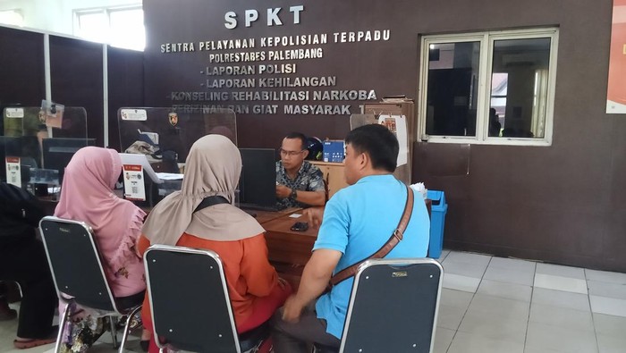 Nilawati (38) lapor polisi karena dianiaya tetangga lapaknya di pasar samping Polrestabes Palembang.