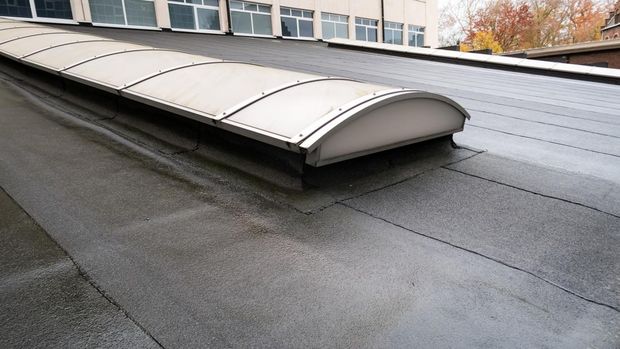 Plastic dome on a flat roof on a large building in the heart of the city