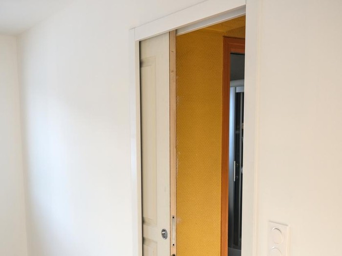 Pocket door in a white plasterboard wall (sliding door inside a wall)