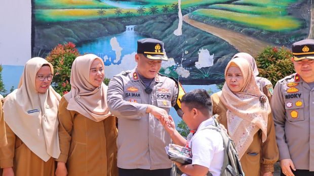 Kapolres Rohil AKBP Isa Imam Syahroni menggelar makan bergizi gratis di SD Negeri 020 Ujung Tanjung, Rohil, Riau. (dok. Polres Rohil)