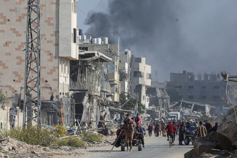 Displaced Palestinians make their way after fleeing the northern part of Gaza amid an Israeli military operation, in Gaza City, November 12, 2024. REUTERS/Dawoud Abu Alkas