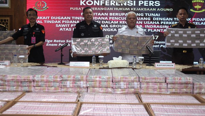 Direktur Penyidikan Jaksa Agung Muda Tindak Pidana Khusus Abdul Qohar (kiri) bersama Kapuspenkum Kejagung Harli Siregar (tengah) menunjukkan uang sitaan saat menyampaikan keterangan terkait dengan kasus tindak pidana korupsi dan pencucian uang di Kejaksaan Agung, Jakarta, Selasa (12/11/2024). Kejaksaan Agung melalui Direktorat Penyidikan Jaksa Agung Muda Tindak Pidana Khusus (Jampidsus) menyita aset senilai Rp301,9 miliar yang terkait dengan kasus tindak pidana korupsi dan pencucian uang yang melibatkan PT Duta Palma Group. ANTARA FOTO/Reno Esnir/sgd/foc.