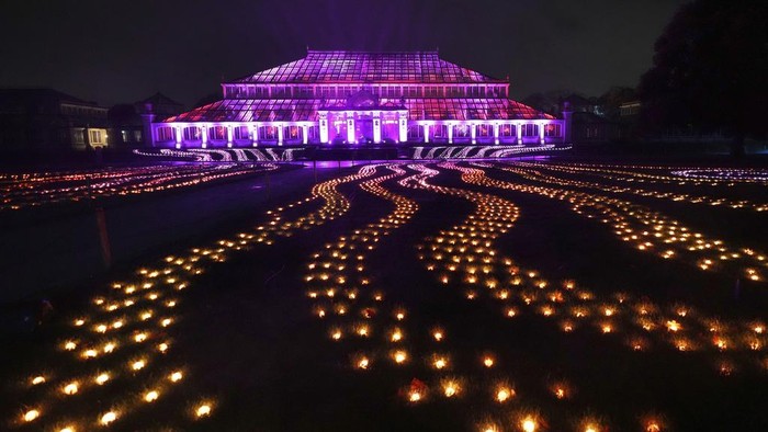 A light display seen towards the Temperate House at the Christmas light trail as it returns for its12th year with new installations set within the UNESCO World Heritage Site landscape of Kew Gardens in London, England, Tuesday, Nov. 12, 2024. (AP Photo/Kirsty Wigglesworth)