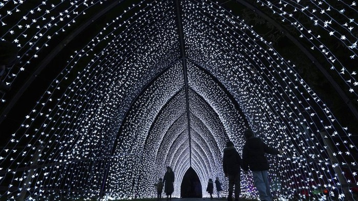 A light display seen towards the Temperate House at the Christmas light trail as it returns for its12th year with new installations set within the UNESCO World Heritage Site landscape of Kew Gardens in London, England, Tuesday, Nov. 12, 2024. (AP Photo/Kirsty Wigglesworth)
