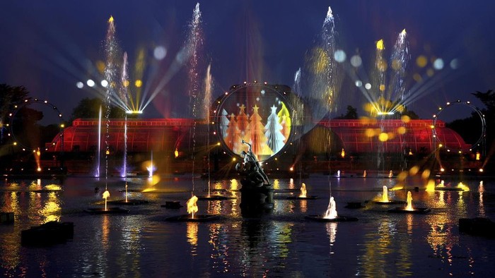 A light display seen towards the Temperate House at the Christmas light trail as it returns for its12th year with new installations set within the UNESCO World Heritage Site landscape of Kew Gardens in London, England, Tuesday, Nov. 12, 2024. (AP Photo/Kirsty Wigglesworth)
