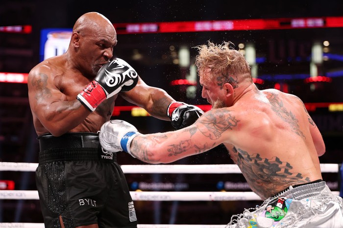 ARLINGTON, TEXAS - NOVEMBER 15: (L-R) Mike Tyson and Jake Paul fight during LIVE On Netflix: Jake Paul vs. Mike Tyson at AT&T Stadium on November 15, 2024 in Arlington, Texas. (Photo by Al Bello/Getty Images for Netflix © 2024)