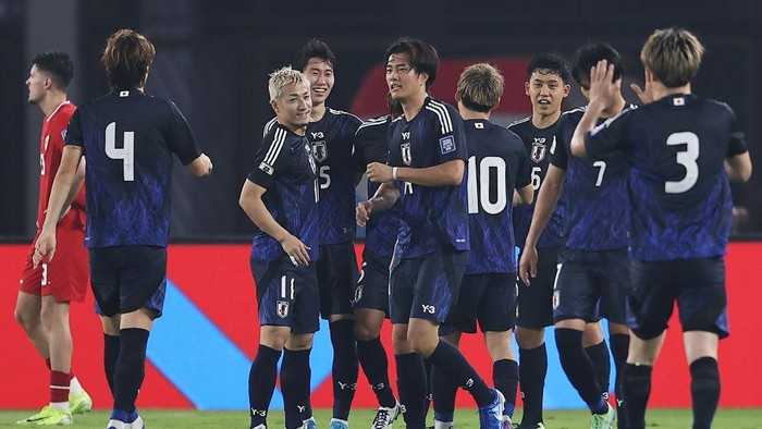 JAKARTA, INDONESIA - NOVEMBER 15: Hidemasa Morita (4L) of Japan celebrates with teammates after scoring their teams third goal against Indonesia in the second half during the FIFA World Cup Asian 3rd Qualifier Group C match at Gelora Bung Karno Stadium on November 15, 2024 in Jakarta, Indonesia. (Photo by Robertus Pudyanto/Getty Images)