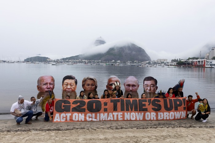 Members of the Indigenous People Association stage a protest to demand action on climate change, holding big head cut-outs of world leaders U.S. President Joe Biden, Chinas President Xi Jinping, European Commission President Ursula von der Leyen, Indias Prime Minister Narendra Modi, Russian President Vladimir Putin and Japans Prime Minister Shigeru Ishiba, on the waters of Botafogo Bay,  ahead of the G20 Summit, in Rio de Janeiro, Brazil November 16, 2024. REUTERS/Tuane Fernandes     TPX IMAGES OF THE DAY
