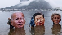 Organisasi-organisasi adat menenggelamkan potongan-potongan wajah raksasa para pemimpin G20 di Teluk Botafogo, di Rio de Janeiro. Aksi ini untuk memprotes apa yang mereka sebut sebagai kelambanan global dalam upaya menghentikan perubahan iklim.