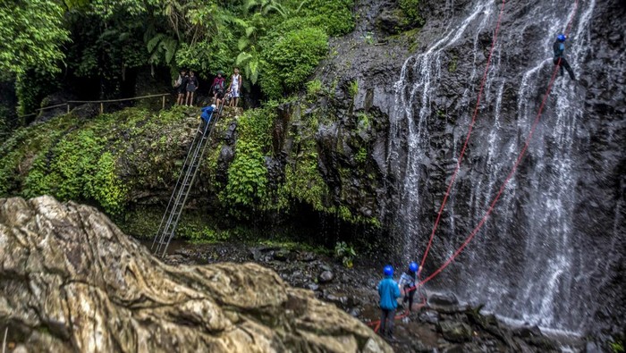 Wisatawan menggunakan wahana wisata di Curug Aseupan di kawasan Curug Tilu Leuwi Opat, Kabupaten Bandung Barat, Jawa Barat, Minggu (17/11/2024). Kawasan yang memiliki tiga air terjun atau curug tersebut menawarkan berbagai wahana aktivitas luar ruangan yang berpotensi menjadi destinasi wisata unggulan dan dapat meningkatkan kunjungan pariwisata serta perekonomian masyarakat di kawasan tersebut. ANTARA FOTO/Abdan Syakura/agr/nym.