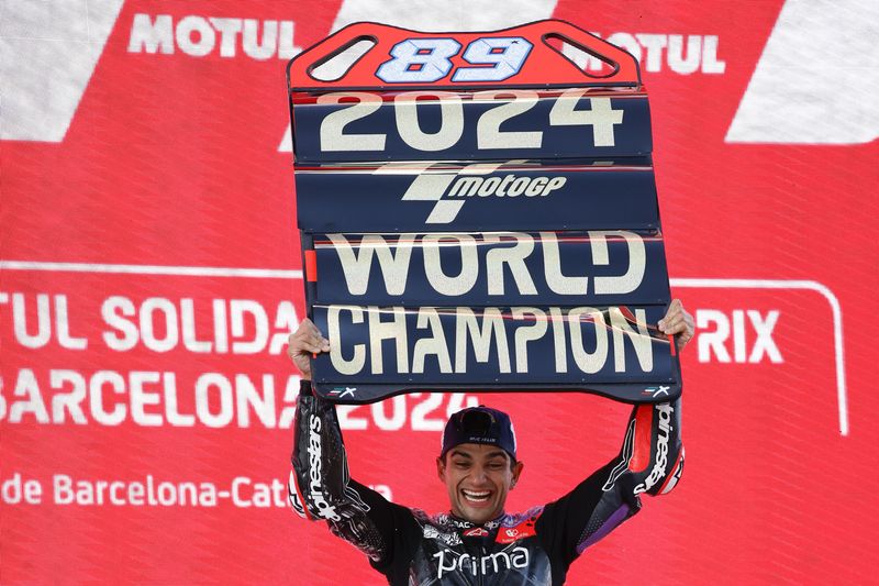 Moto GP World Champion winner Spain's rider Jorge Martin of the Prima Pramac Racing celebrates on the podium after finishing third during the MotoGP race of the Grand Prix of Barcelona at the Catalunya racetrack in Montmelo, just outside of Barcelona, Spain, Sunday, Nov. 17, 2024. (AP Photo/Joan Monfort)