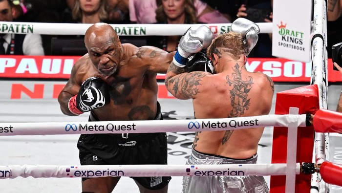 ARLINGTON, TEXAS - NOVEMBER 15: Mike Tyson (in black short) and Jake Paul (in silver short) exchange punches during their heavyweight world titles of the Premiere Boxing Championship on Friday night at AT&T Stadium in Arlington, Texas, United States on November 15, 2024. (Photo by Tayfun Coskun/Anadolu via Getty Images)