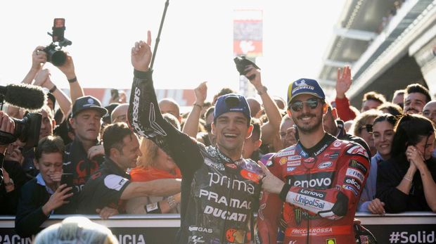 BARCELONA, SPAIN - NOVEMBER 17:  Jorge Martin of Spain and Prima Pramac Racing celebrates the 2024 World MotoGP champion under the podium with Francesco Bagnaia of Italy and Ducati Lenovo Team (R) at the end of the  MotoGP race during the Motul Solidarity Grand Prix of Barcelona - Race at Circuit de Barcelona-Catalunya on November 17, 2024 in Barcelona, Spain. (Photo by Mirco Lazzari gp/Getty Images)