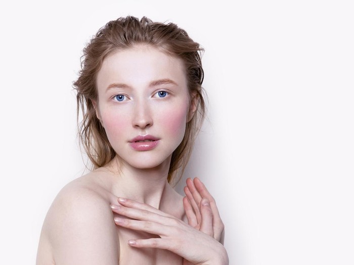 Beautiful young woman with pale white skin rose color blush cheeks and pink lipstick Looking fresh and lovely Fashion model close-up studio portrait Exstraordinaly elf and princess - like beauty