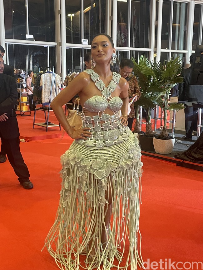 Namun, bagian gaun yang paling disukainya adalah rok yang dibuat dengan teknik makrame sehingga terlihat mengembang. Aku entah kenapa merasa ini simbolisasi alam juga, dan aku merasa dekat sekali dengan pohon beringin, jadi aku merasa ini sangat Indonesia sih. Menurut Mas Toton (soal pohon beringin) mungkin bukan. Ya ini perasaan aku pribadi karena aku di rumah juga ada pohon beringin. Jadi aku merasa dekat dengan pohon beringin. Jadi aku ngerasa memakai rumahku sendiri, tuturnya lagi. (Foto: Pingkan Anggraini/detikpop)