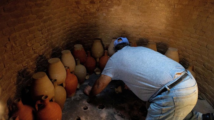 Dimitris Kouvdis, 70, works in his pottery workshop using traditional methods in Agios Stefanos village, near Mandamados on the Greek island of Lesbos, Greece, September 5, 2024. His family’s dedication to preserving the craft was recently honored with inclusion in UNESCO’s National Inventory of Intangible Cultural Heritage. REUTERS/Elias Marcou REFILE CORRECTING 