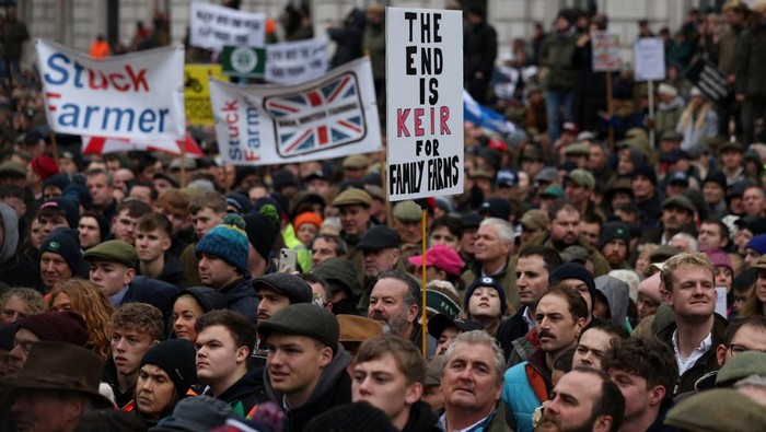 People hold placards during a demonstration protesting against the Labour government's new agricultural policy, which includes a budget measure expected to increase inheritance tax liabilities for some farmers, in London, Britain, November 19, 2024. REUTERS/Hollie Adams