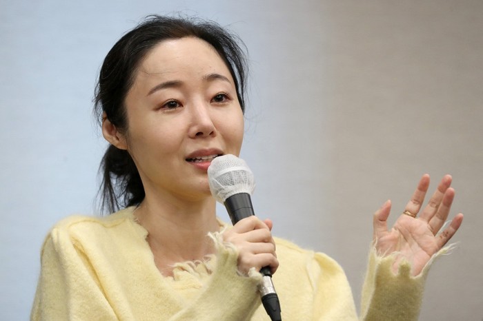 SKOREA-MUSIC-KPOP-HYBE Min Hee-jin, CEO of ADOR, a subsidiary label of K-pop powerhouse HYBE, reacts during a press conference following her companys shareholder meeting in Seoul on May 31, 2024. (Photo by Han Myung-Gu / POOL / AFP)