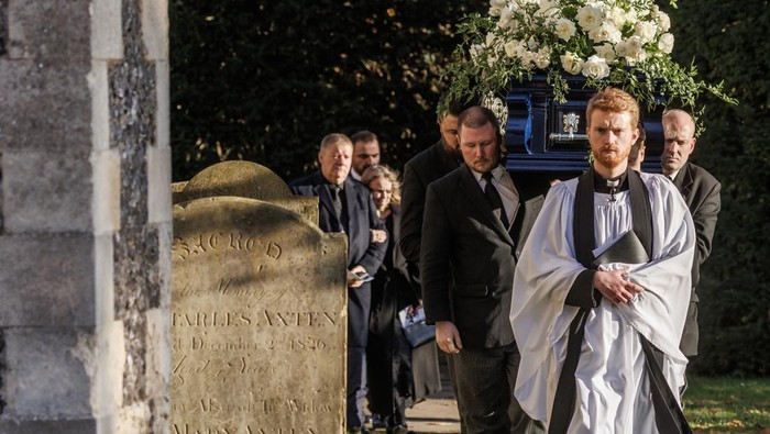 AMERSHAM, ENGLAND - NOVEMBER 20: A priest leads the coffin out following the funeral of singer Liam Payne, former member of One Direction, on November 20, 2024 in Amersham, United Kingdom. Former One Direction star Liam Payne's private funeral in Amersham has been widely anticipated to draw celebrities and fans alike, wishing to pay their final respects. The singer died after falling from a hotel balcony in Buenos Aires on October 16. (Photo by Dan Kitwood/Getty Images)