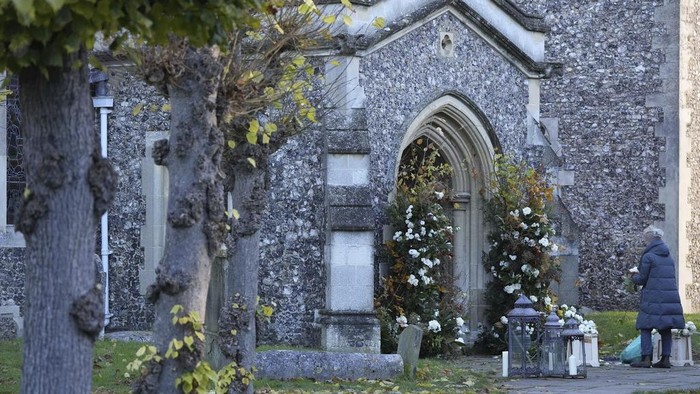 A florist arranges flowers ahead of the funeral service for One Direction singer Liam Payne at a church in the Home Counties, England, Wednesday Nov. 20, 2024. (Andrew Matthews/PA via AP)