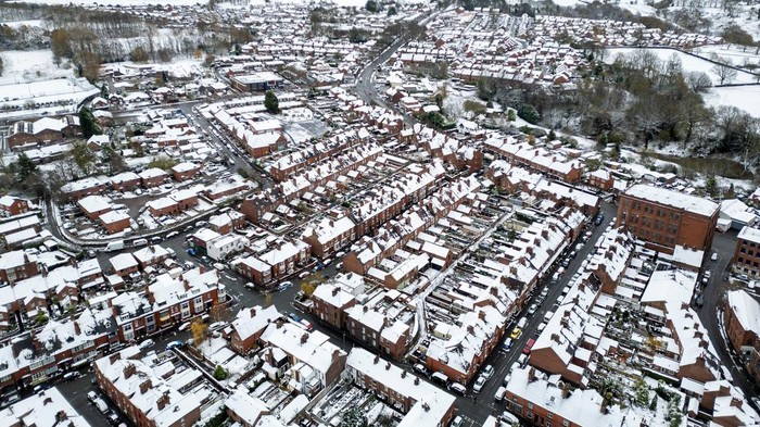 A drone view shows snow covering the roof tops of houses in Buxton, Britain, November 19, 2024. REUTERS/Phil Noble