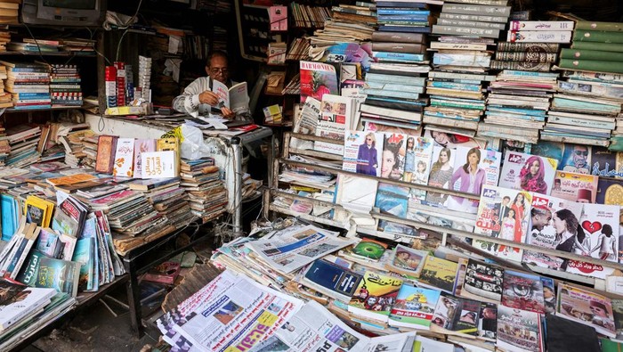 A man reads a newspaper in Edward Gendy's kiosk, despite the digital shift, in Ismailia, Egypt, November 18, 2024. REUTERS/Mohamed Abd El Ghany