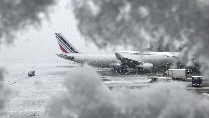 An Air France plane sits on the tarmac during a snowfall at Charles de Gaulle airport, north of Paris, Thursday, Nov. 21, 2024. (AP Photo/Masha Macpherson)