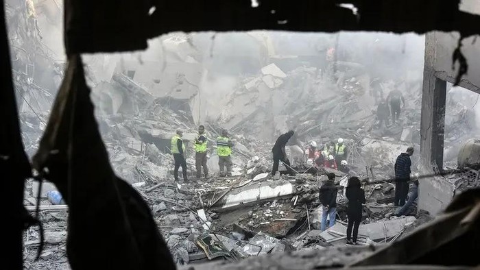 Rescuers sift through the rubble of a levelled building, following an overnight Israeli airstrike that targeted Beirut’s Basta neighbourhood on November 23, 2024. (AFP)