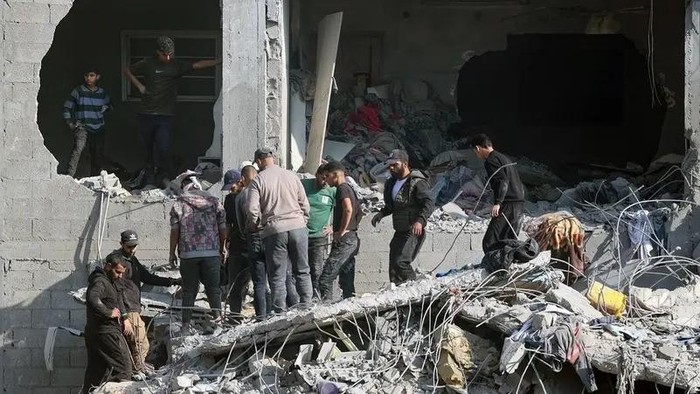 Palestinians check the rubble of a building in the aftermath of an Israeli strike south of Gaza City, on November 22, 2024. (AFP)