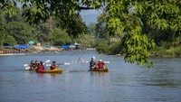 Sungai Nam Song menjadi daya tarik utama bagi wisatawan, menawarkan aktivitas tubing yang santai sambil menikmati panorama alam di sekitarnya.