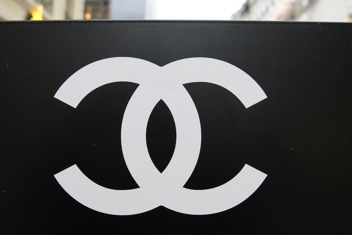 Chanel logo is pictured on a valet sign outside a Chanel boutique Wednesday, Dec. 15, 2021 in Paris. The French luxury fashion house Chanel has chosen Leena Nair, an industry outsider from India and longtime executive at Unilever, to be its new CEO. (AP Photo/Christophe Ena)
