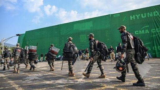 Paramilitary soldiers deploy at the Red Zone area blocked with shipping containers ahead of a protest rally by supporters of jailed former prime minister Imran Khan's Pakistan Tehreek-e-Insaf (PTI) party in Islamabad on November 24, 2024. Authorities block roads in Islamabad with shipping containers and set up beefed up security after jailed opposition leader Imran Khan's Pakistan Tehreek-e-Insaf (PTI) party calls for fresh protests to demand his release. (Photo by Aamir QURESHI / AFP)