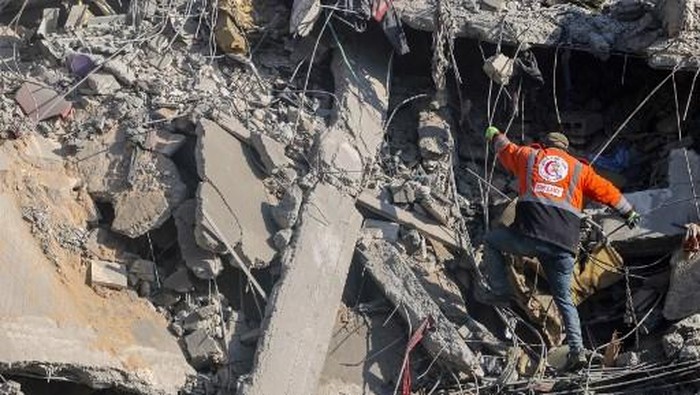 A Palestinian rescuer checks the rubble of a building in the aftermath of an Israeli strike south of Gaza City on November 22, 2024, as the war between Israel and Hezbollah continues. (Photo by Omar AL-QATTAA / AFP)