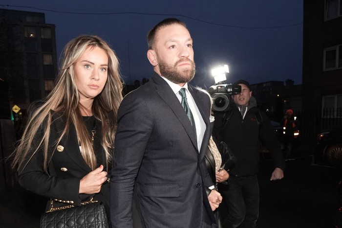 Dublin , Ireland - 22 November 2024; Mr Conor McGregor leaves court, accompanied by his partner Dee Devlin, after the court announced the jurys decision in the civil action case, P Ní Laimhin v McGregor & Anor, in High Court 24 at Chancery Place in Dublin.