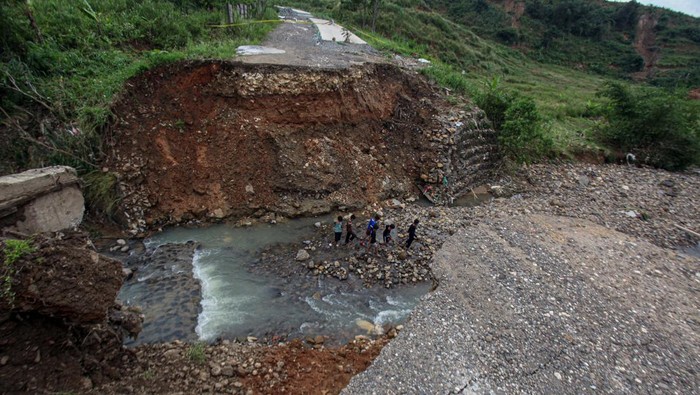 Kondisi jalan yang terputus akibat longsor dan jembatan terbawa arus sungai di Desa Hambalang, Kabupaten Bogor, Jawa Barat, Kamis (28/11/2024). Jembatan di Jalan Puncak 2 penghubung Desa Hambalang Kecamatan Citeureup, dan Desa Babakan Madang Kecamatan Babakan Madang tersebut longsor dan ambruk terbawa arus sungai karena hujan deras pada Rabu (27/11/2024) sehingga akses jalan tersebut putus ANTARA FOTO/Yulius Satria Wijaya/aww.