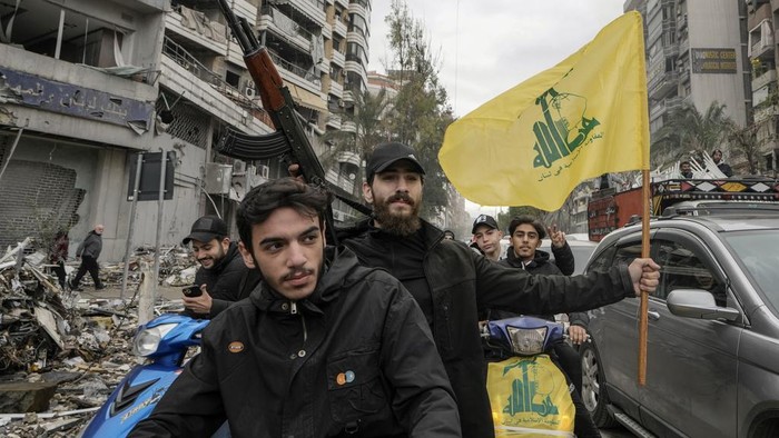 Hezbollah supporters celebrate as they return to Dahiyeh, in Beirut, Lebanon, following a ceasefire between Israel and Hezbollah that went into effect on Wednesday, Nov. 27, 2024. (AP Photo/Bilal Hussein)