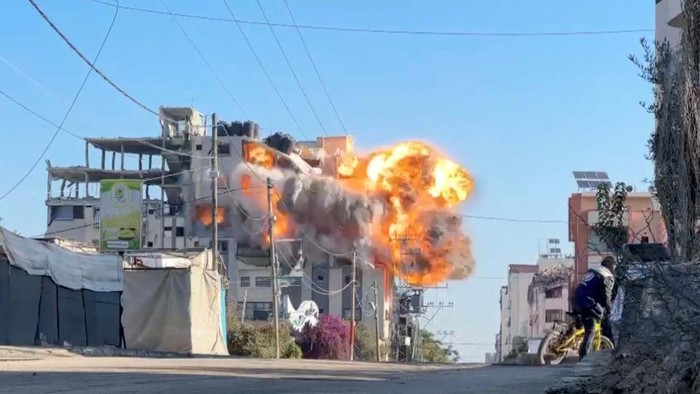 Smoke billows from a residential building hit by an Israeli strike, amid the ongoing conflict between Israel and Hamas, in Nuseirat refugee camp, in the central Gaza Strip, November 28, 2024, in this screengrab taken from a video. Reuters TV/via REUTERS     TPX IMAGES OF THE DAY