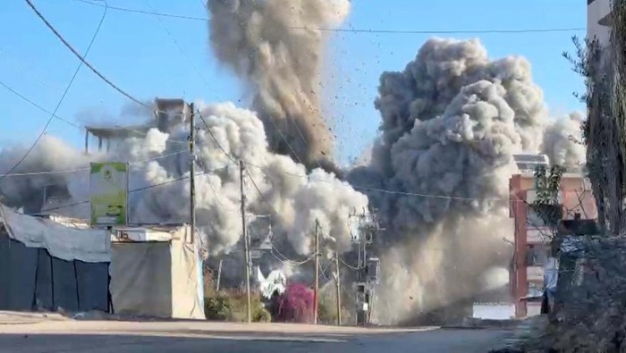 Smoke billows from a residential building hit by an Israeli strike, amid the ongoing conflict between Israel and Hamas, in Nuseirat refugee camp, in the central Gaza Strip, November 28, 2024, in this screengrab taken from a video. Reuters TV/via REUTERS     TPX IMAGES OF THE DAY