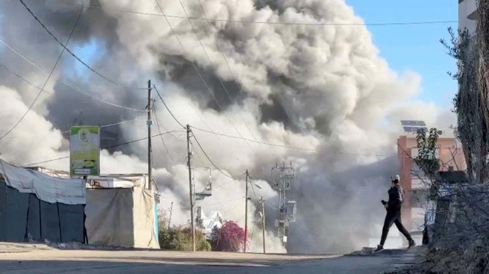 Smoke billows from a residential building hit by an Israeli strike, amid the ongoing conflict between Israel and Hamas, in Nuseirat refugee camp, in the central Gaza Strip, November 28, 2024, in this screengrab taken from a video. Reuters TV/via REUTERS     TPX IMAGES OF THE DAY