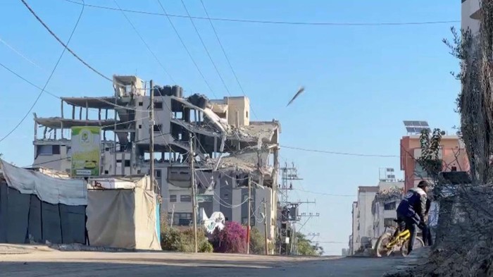 Smoke billows from a residential building hit by an Israeli strike, amid the ongoing conflict between Israel and Hamas, in Nuseirat refugee camp, in the central Gaza Strip, November 28, 2024, in this screengrab taken from a video. Reuters TV/via REUTERS     TPX IMAGES OF THE DAY