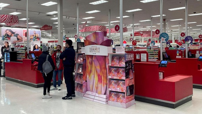 Shoppers mill about a display showing Taylor Swift merchandise at a Target in Edgewater, New Jersey, U.S., November 29, 2024. REUTERS/Siddharth Cavale