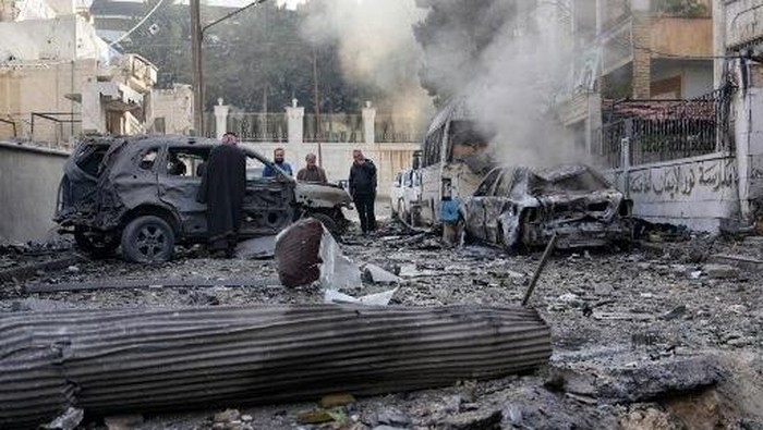 People check the damage at the scene of a pro-regime forces strike that targeted a neighbourhood in Syrias rebel-held northern city of Idlib on December 1, 2024. A Syria war monitor said rebels seized Aleppos civilian airport on November 30, the first time they have taken such a facility, along with key towns in Idlib and Hama provinces as they waged a days-long offensive. (Photo by MUHAMMAD HAJ KADOUR / AFP)