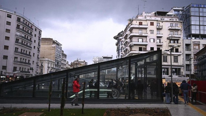 Commuters walk around a metro station during the inauguration day of the Thessaloniki metro, in Thessaloniki, northern Greece, Saturday, Nov. 30, 2024. (AP Photo/Giannis Papanikos)