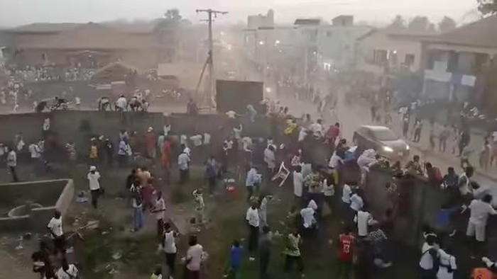 People scramble in Nzerekore, Guinea, where local officials said a deadly stampede ensued at a stadium following fan clashes during a soccer match, December 1, 2024, in this still image obtained from a social media video. Social media via REUTERS Purchase Licensing Rights