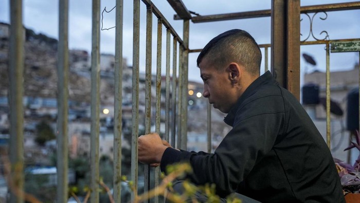 Palestinian Ayham al-Salaymeh, 14, who was sentenced to one year in prison by an Israeli court and spent 18 months under house arrest on charges of throwing stones at Israelis in Jerusalem, looks out from his family's house days before surrendering to serve his sentence in an Israeli jail, in East Jerusalem, November 25, 2024. REUTERS/Latifeh Abdellatif     TPX IMAGES OF THE DAY