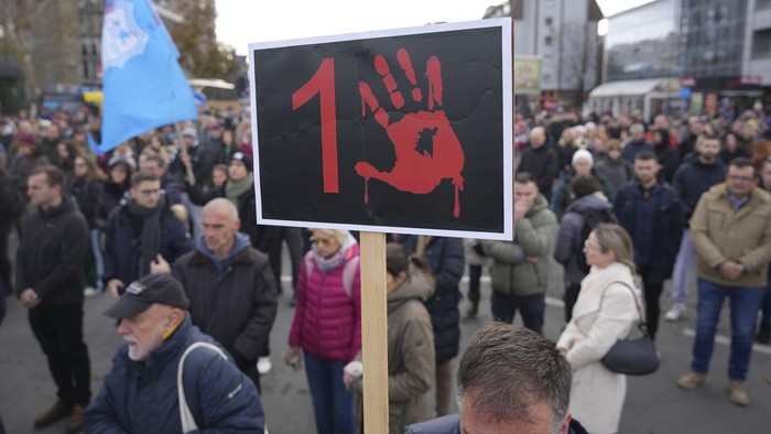 People march during a protest following the collapse of a concrete canopy at the railway station that killed 15 people one month ago, in Novi Sad, Serbia, Sunday, Dec. 1, 2024. (AP Photo/Darko Vojinovic)